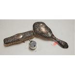 An Art Nouveau silver backed hairbrush; together with a matching hand brush; and a George V silver