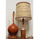 A 1970s Danish turned teak table lamp, having tapering neck with embroidered shade, h.44cm (