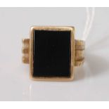 A yellow metal and black onyx set gent's signet ring, unmarked but tests as approx 14ct, gross