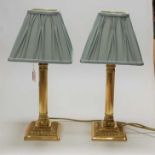 A pair of reproduction lacquered brass bedside lamps, each having pleated silk shades, gross h.42cm