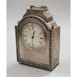 An early 20th century silver plated cased mantel clock, having convex enamelled dial with Roman