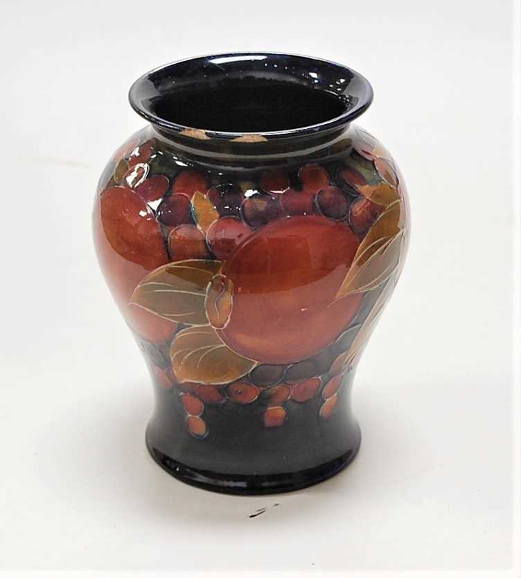 An early 20th century Moorcroft pottery vase, decorated in the Pomegranate pattern, impressed