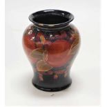 An early 20th century Moorcroft pottery vase, decorated in the Pomegranate pattern, impressed