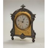 A British United Clock Company brass and pewter framed strut clock, the signed circular dial with