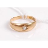 An 18ct gold diamond solitaire ring, the old cut diamond in a Gypsy setting and weighing approx 0.