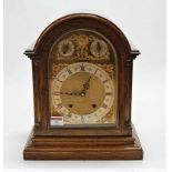 An early 20th century oak cased dome topped mantel clock, formally with striking and chiming