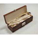 A brown leather glove box containing various lady's kid leather and other gloves