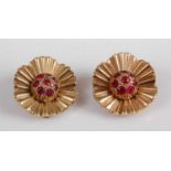 A pair of yellow metal Marguerite style cluster earrings, each comprising eight round rubies to