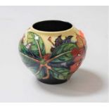 A modern Moorcroft pottery vase, of squat circular form, having typical tube-lined decoration,