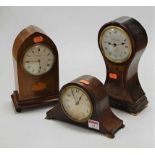 An Edwardian mahogany and inlaid Gothic influenced mantel clock, having indistinctly signed convex