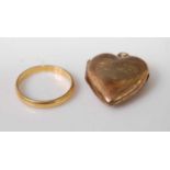 A 22ct gold wedding band, 2.9g, size P; together with a gold plated heart shaped pendant locket (2)