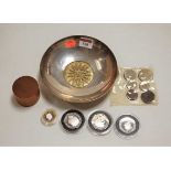 A small silver plated shallow bowl, containing various coins to include 2007 Solomon Islands ten