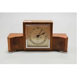 An Art Deco Elliot walnut and figured walnut cased mantel clock, the silvered dial signed by the