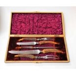 A late Victorian walnut cased five-piece carving set, having embossed white metal collars and antler