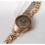 A lady's 9ct gold cased manual wind wristwatch, on gilt metal bracelet, case dia.18mm