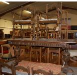 A contemporary 17th century style moulded oak dining suite, comprising; refectory table raised on