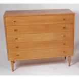 A 1960s Danish teak squarefront chest, of five long drawers, having shaped fingerhole handles,