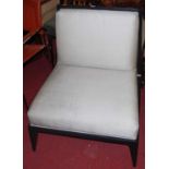 A contemporary ebonsied and upholstered easy chair, w.74cm