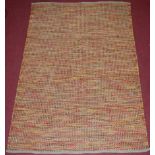 A contemporary hessian and coloured string embroidered rug