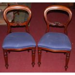 A set of six Victorian style mahogany balloon back dining chairs, each having blue floral