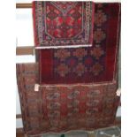 A Persian woollen red ground Bokhara rug; together with a similar slightly smaller Persian woollen