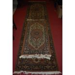 A Persian style machine woven long hall runner, 350 x 94cm; together with two matching smaller