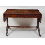A Regency mahogany and rosewood crossbanded sofa table, having single real and single dummy drawer