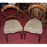 A set of six mid-Victorian mahogany balloon back dining chairs, each having stuffover seats and