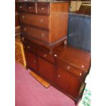 A Stag Minstrel sideboard, having three frieze drawers over conforming cupboard doors, w.141cm;