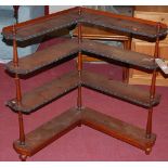 A circa 1900 mahogany open four-tier corner bookshelf, on turned supports, h.90cm, d.77cm