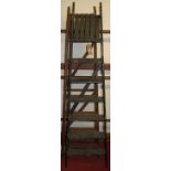 A stained wood hinged decorator's ladder; together with a matching black painted example (2)