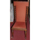 A Victorian mahogany prie-deux, having upholstered padback and seat, within spiral turned columns