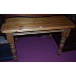 A modern pine round cornered kitchen table, raised on turned supports, length 106cmCondition report: