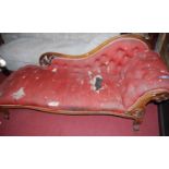 A mid-Victorian carved walnut framed button chaise-longue, with raised and pierced floral scroll