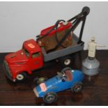 A collection of tinplate vehicles and accessories, to include a Schuco No.1070 Grand Prix racer, a