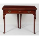 A George II mahogany tea table, having a fold-over top on gateleg rear action, above a single frieze