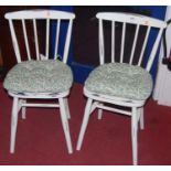 A set of four contemporary white painted stickback kitchen chairs