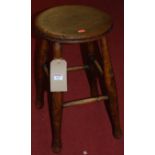 An early 20th century provincial circular elm topped and beech stool
