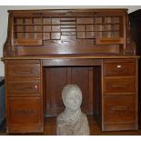A 1930s oak rolltop twin pedestal writing desk, the tambour mechanism enclosing fitted interior with