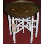 An early 20th century Eastern engraved brass circular folding Benares table