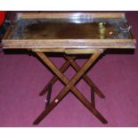 An Eastern floral relief carved teak tray-top butlers table, on folding stand, length 81.5cm