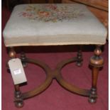 An early 20th century walnut and floral tapestry embroided dressing stool, raised on bulbous and