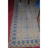 A large European machine woven rug, decorated with floral motifs within roundels, 350 x 260cm;