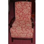 An early 20th century stained beech framed and red floral upholstered open armchair