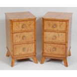 A pair of Art Deco burr walnut three-drawer bedside chests, each having plain canted corners with