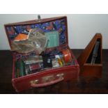 A vintage suitcase containing a quantity of various table lighters, razors etc; together with a