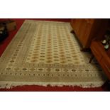 A large Persian woollen cream ground Bokhara rug, having multiple trailing tramline borders, 320 x