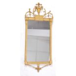 A late 18th century giltwood and gesso wall mirror, having a central urn and entwined foliate