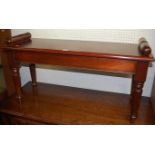 A Victorian style mahogany twin window seat, having typical rolled ends and raised on turned and