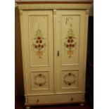 A circa 1900 Continental and later floral cream painted pine double door armoire, having single long